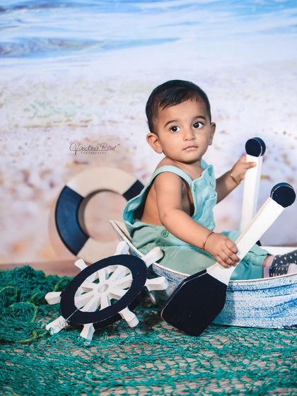 Explore our full nautical and beach-themed collection. These images showcase the variety of poses and angles possible with our boat prop, sand-colored flooring, and ocean backdrop.