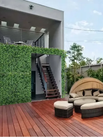 I love mixing materials to create a modern look. Here, I used a lush vertical garden wall to contrast with the warm wooden deck, creating a stylish outdoor lounge area. This is a great way to add greenery without losing floor space.