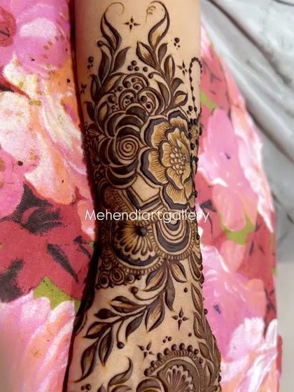 A close-up view of a detailed floral cuff design on the forearm. This is often part of a larger bridal piece, showing the level of detail I put into every part of the design.