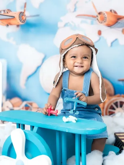 A joyful pilot celebrating his first birthday. The "1" prop ties the theme and milestone together perfectly.