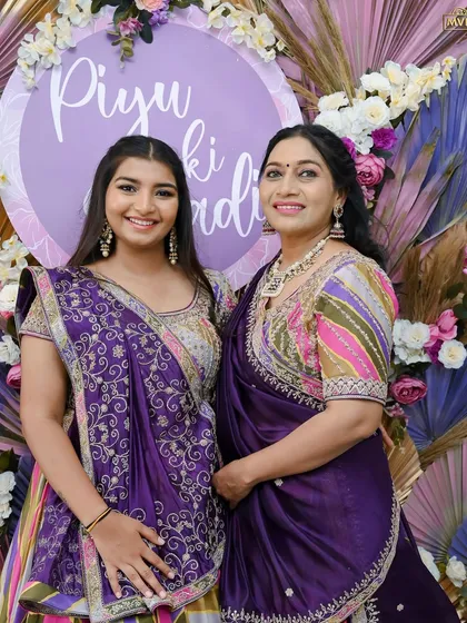 A lovely mother-daughter portrait, showcasing their beautiful traditional outfits against our bespoke backdrop.