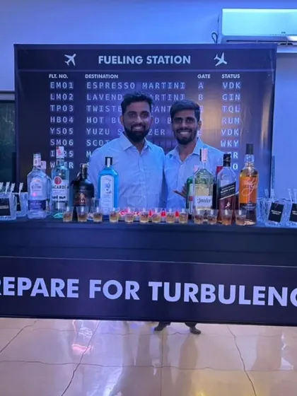 Your event's theme is our blueprint. This 'Flight Bar' setup, complete with a 'Fueling Station' menu and a 'Prepare for Turbulence' sign, shows how we build a complete, immersive bar concept from the ground up.