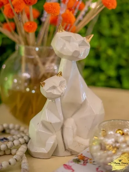 Another view of the elegant geometric cat figurines, this time with gold-tipped ears, adding a subtle touch of luxury to a tabletop arrangement.