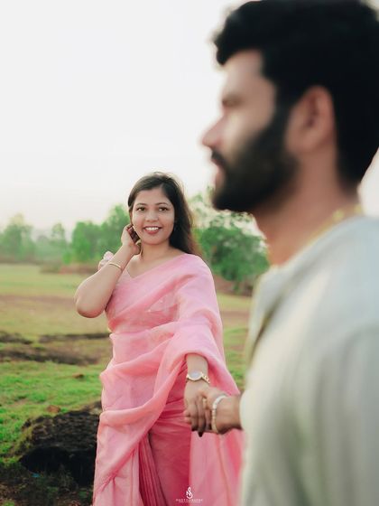 A creative shot with him in the foreground, leading her by the hand. This "follow me" style is a beautiful way to symbolize their journey together.