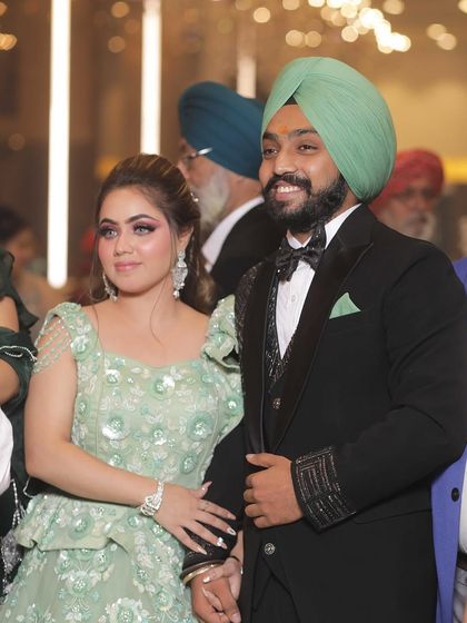 The happy couple. Her makeup complements his sharp look, making them a picture-perfect pair.