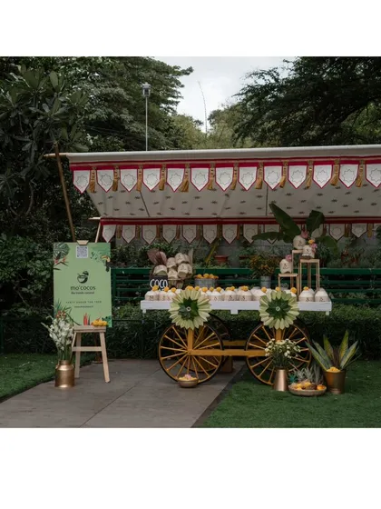 The full view of our elegant "Coco Bar" cart. The cart was decorated with a custom canopy and floral arrangements, creating a beautiful and inviting welcome station for guests.