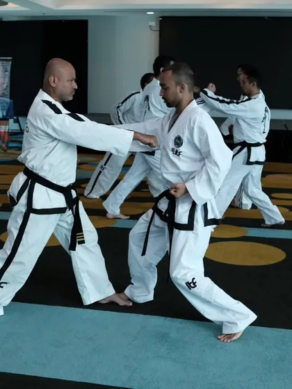 Practicing a blocking and striking sequence with a fellow instructor at a seminar. These partner drills are essential for understanding the practical application of techniques.