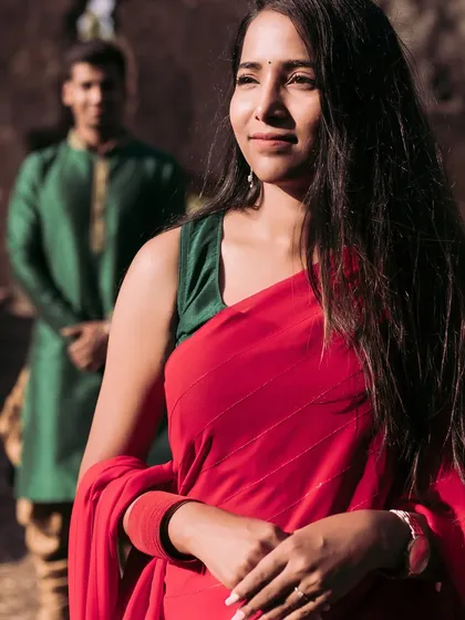 A thoughtful portrait of the bride-to-be, with her partner standing softly out of focus in the background. This composition tells a story of love and contemplation.