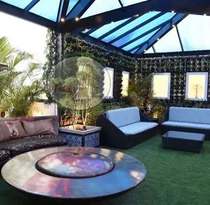 This is what we mean by luxury outdoor living. We designed this terrace with a spacious, all-weather wicker sofa set and a central fire pit table, creating the perfect spot for family gatherings. The entire space is built on a foundation of our zero-maintenance artificial grass, giving you a lush green look without the hassle.