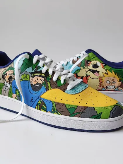 Both shoes together, showing how the two different comic worlds are united by a shared background of foliage and a primary colour palette.