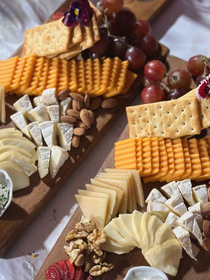 A close up of our artisanal cheese boards, featuring a curated selection of hard and soft cheeses, nuts, grapes, and assorted crackers. This was part of our exclusive catering for 'Fabulous Lives of Bollywood Wives'.