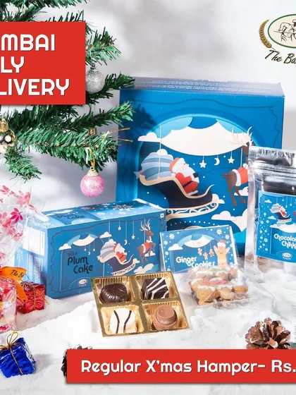Our Regular Christmas Hamper is a curated selection of festive treats. It includes a plum cake, assorted chocolates, ginger cookies, and chocolate chikkis, all packed in our beautiful holiday-themed box.