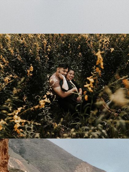 A beautiful shot of a couple nestled in a field of yellow wildflowers, capturing a moment of pure happiness.