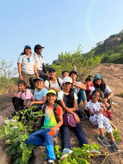 A happy group of our Young Adventurers and their instructors posing for a photo on the rocks during a hike. We focus on creating a fun, safe environment where kids can build confidence and make new friends.
