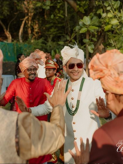 The groom dancing with his friends and family as he makes his way to the wedding venue.