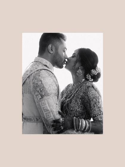 A tender kiss, captured in soft black and white. This intimate portrait of Krunal and Rashmi is a quiet, beautiful moment that speaks volumes about their love.
