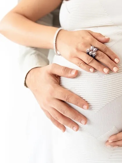 A close-up on the hands and baby bump from a maternity mini session. These sessions are perfect for capturing key moments.