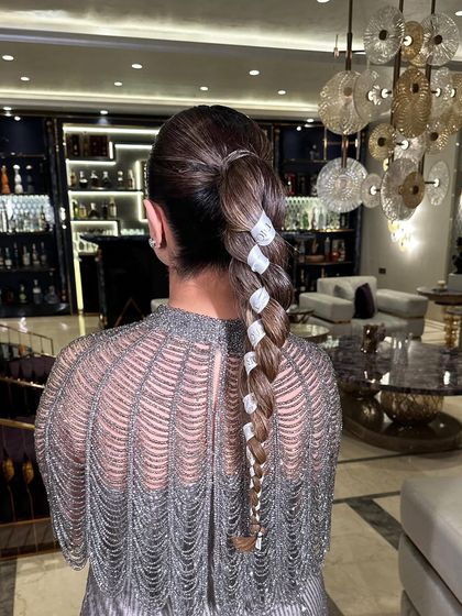 The ribbon-wrapped braid from a different angle, highlighting the clean lines and polished finish.