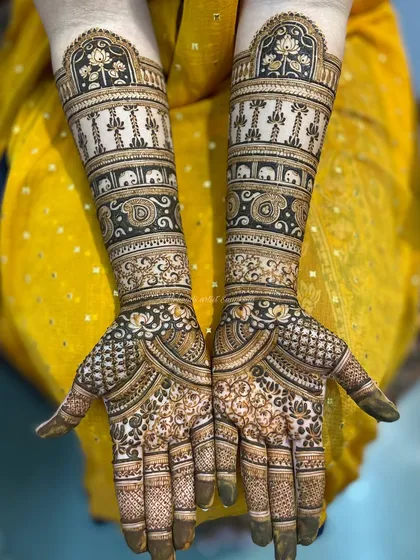 A symmetrical bridal design featuring elephants, hanging decorations, and lotus motifs. The clean lines and detailed patterns showcase the precision and care I put into my work.