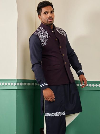 An angled shot of the space blue bundi set, highlighting the embroidery on the cuff and the asymmetrical drape of the kurta.