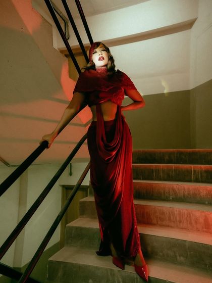 Another angle of the crimson two-piece set, showing how it commands attention with its powerful color and fluid form.