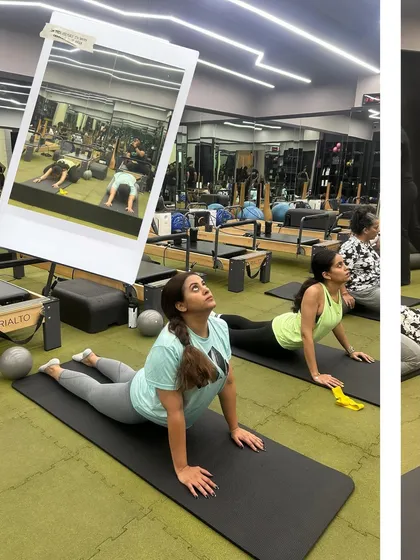 Grab your workout partner and let's flow, flex, and feel good together. This image captures the fun of a buddy workout, with clients doing mat exercises side-by-side.