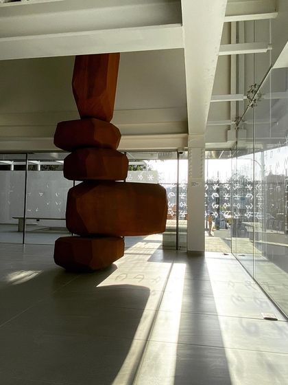 A large wooden sculpture by the artist Arik Levy stands in the lobby of the Museum of Art and Photography (MAP). The double-height space was designed to accommodate large-scale installations and create a dramatic sense of arrival.