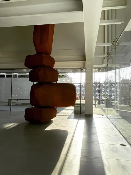 A large wooden sculpture by the artist Arik Levy stands in the lobby of the Museum of Art and Photography (MAP). The double-height space was designed to accommodate large-scale installations and create a dramatic sense of arrival.