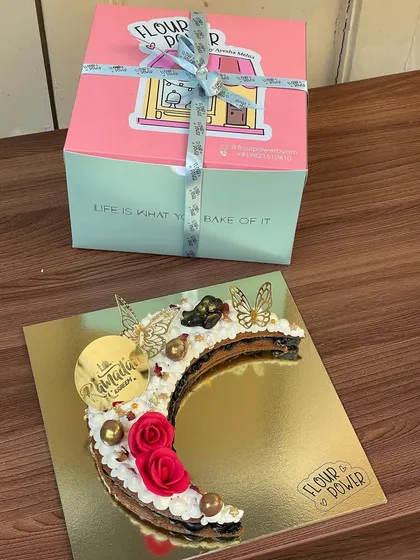 My Eid special crescent moon tart is a beautiful and delicious way to celebrate. It's a cookie tart layered with cream and decorated with roses and butterflies.