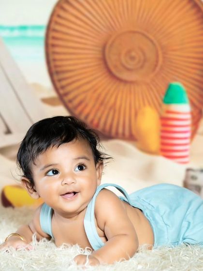 A close-up of the baby's happy face during the beach shoot.