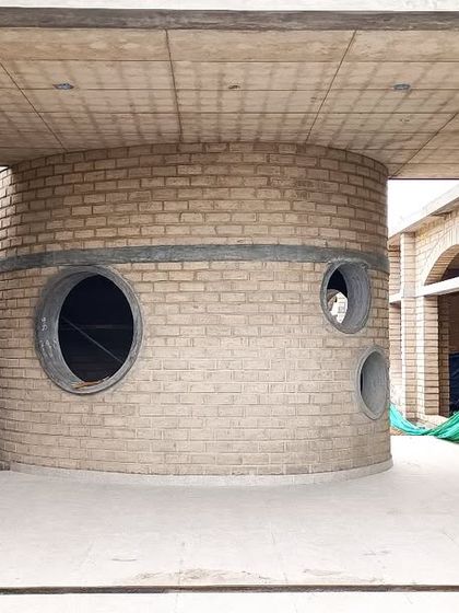 The cylindrical activity room at the heart of Sai Kirupa Special School. The circular windows at different heights offer playful glimpses in and out, creating a unique and engaging space for the students.