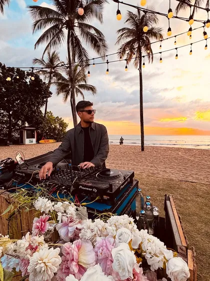 I also specialize in creating the perfect vibe for more intimate, scenic events. Here I am spinning a sunset set at a beautiful beachside gathering, blending music with the magic of the moment.
