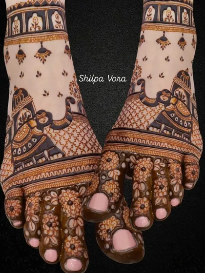A unique bridal foot design featuring elephants and palace gates, with floral patterns on the toes.