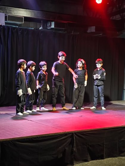 A group of young mimes getting ready for their scene. Our workshops teach children how to use their bodies to tell stories, building confidence and creative expression in a fun, supportive environment.