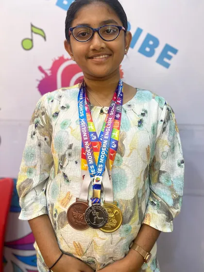 I am so proud of my student Aayushi, a chess champion from our academy. Here she is with her medals after winning first place at the Khel Mahotsav Chess Tournament. Her dedication is an inspiration to all of us.