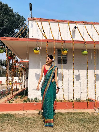 A beautiful teal cotton sari worn for a daytime function. The pop of the red blouse makes the whole look come alive.