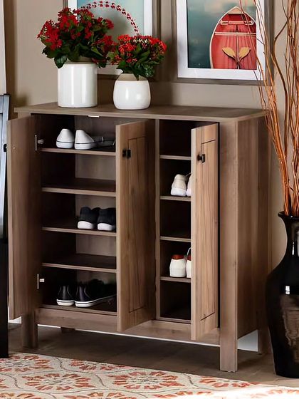 A classic wood-finish shoe cabinet that keeps footwear neatly hidden away. The top surface can be used for placing keys, mail, or decorative items like flowers.
