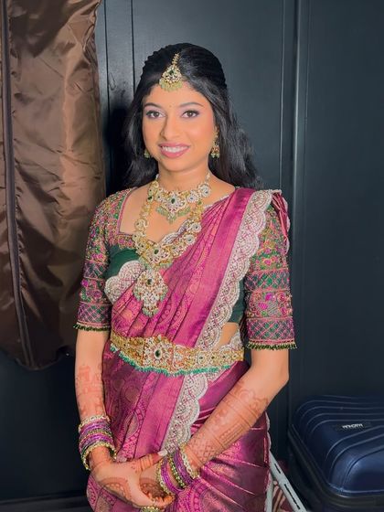 Preethika looking absolutely radiant for her reception. The makeup features a soft glam eye and a balanced lip color, paired with stunning diamond jewellery and a traditional half-up hairstyle.