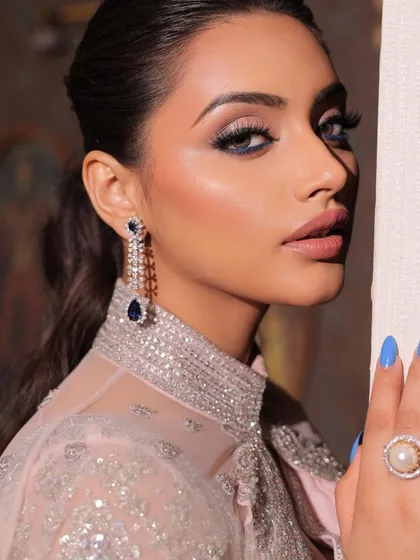 A vision of elegance in a modern saree. This look features bold, smokey eyes and mesmerizing lips, a perfect combination for a cocktail party.