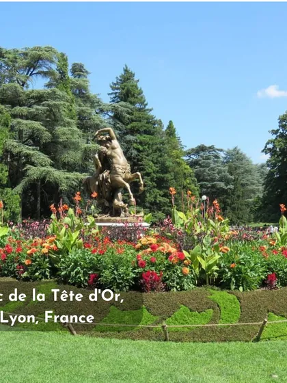 The Parc de la Tête d'Or in Lyon, France, shows how floral design can be integrated with public art and sculpture. The structured planting around the statue creates a beautiful and cohesive scene.