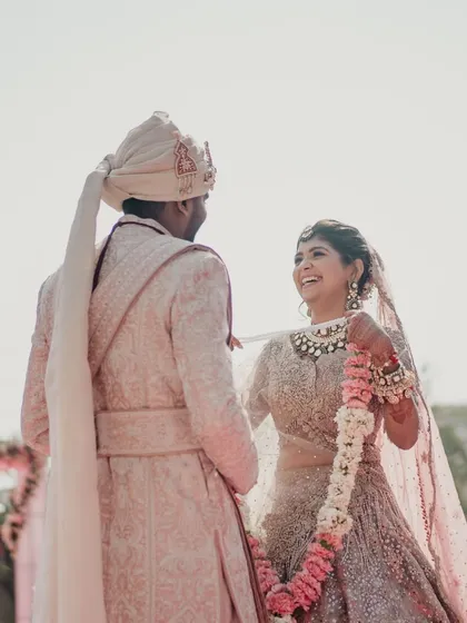 A joyful and candid moment during the varmala ceremony. Our goal is to make sure your wedding day is filled with laughter and happiness.