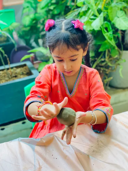 A beautiful shot of a child fully engaged in the creative process. Our studio provides a calm and encouraging environment for this kind of focused, hands-on work.