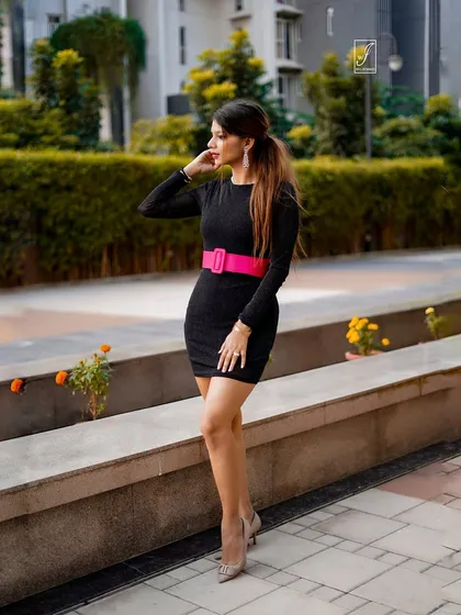 This pose shows the full silhouette of the dress, demonstrating how we capture fashion in a natural, urban environment.