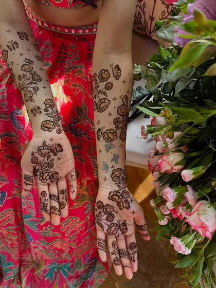 For those who love a lighter touch, I create modern minimalist designs like these scattered floral and butterfly patterns. This style is chic and playful, offering a contemporary take on traditional henna art that feels fresh and personal.