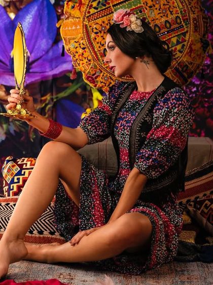 A vibrant, bohemian setting filled with colorful flowers and textiles, created with projection. This technique allows me to build a rich, layered, and festive atmosphere for a unique portrait.
