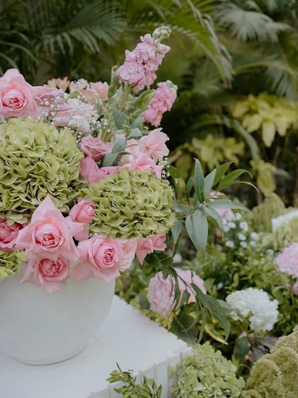 A close-up of the floral installations for Radhika and Anant's ceremony. We used a mix of pink roses and green hydrangeas to create a fresh and natural look that complemented the garden setting.