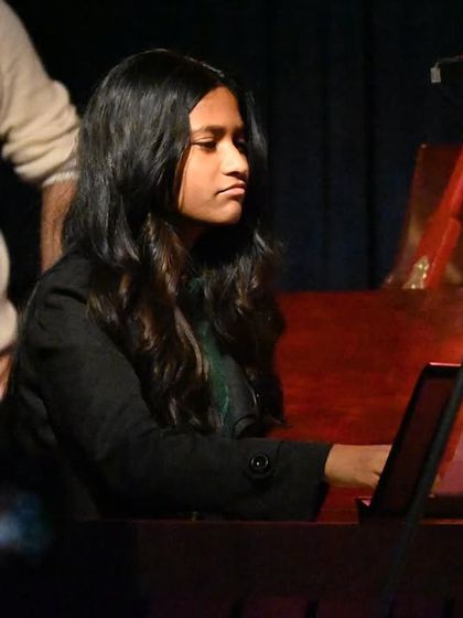 A student pianist showcasing her skills. We prepare our students for the spotlight, focusing on both technical proficiency and expressive performance.