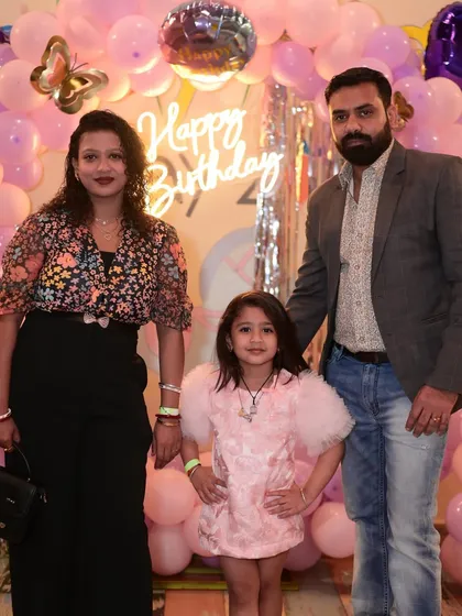 A beautiful family portrait in front of a pink butterfly-themed balloon backdrop. We provide plenty of photo-worthy spots for you to capture your memories.
