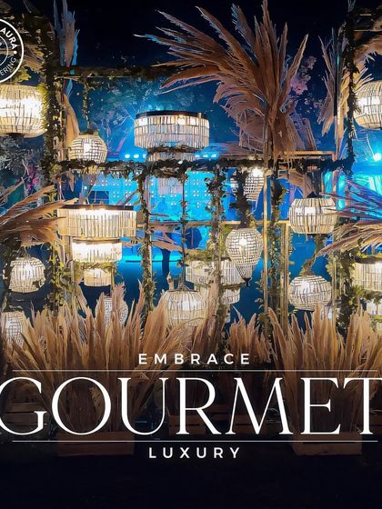 A dramatic lighting installation with pampas grass, showcasing our ability to contribute to "Gourmet Luxury" through ambiance.