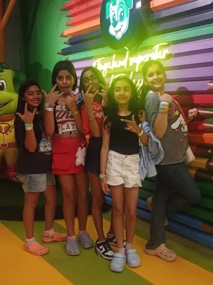 A group of girls celebrates friendship day the Tinga way, posing together with cool hand signs.
